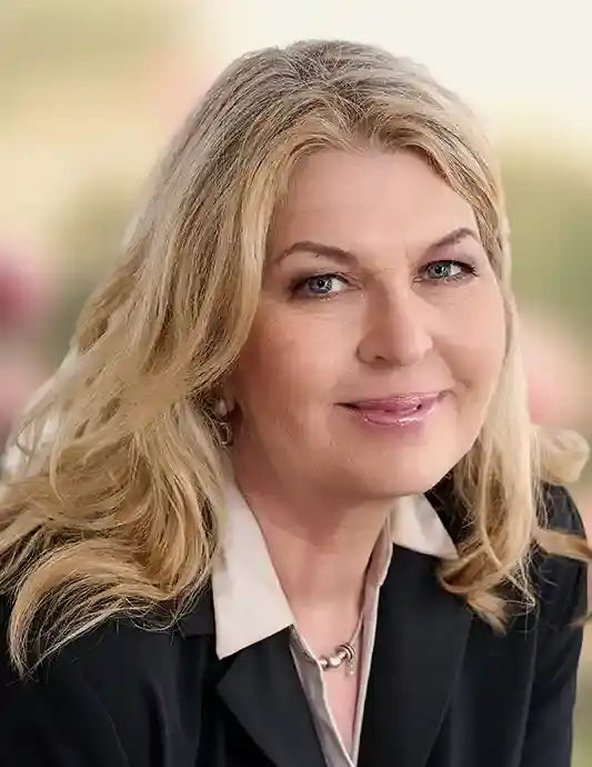 Portrait Anja Artzt, blonde Haare, dunkle Jacke, in Kamera schauend