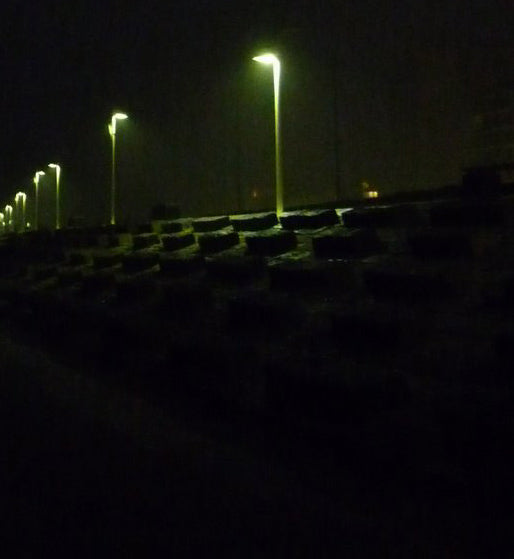Details eIn Foto der Insel Norderney bei Nacht, nur einzelne Lampen sind zu erkennen.